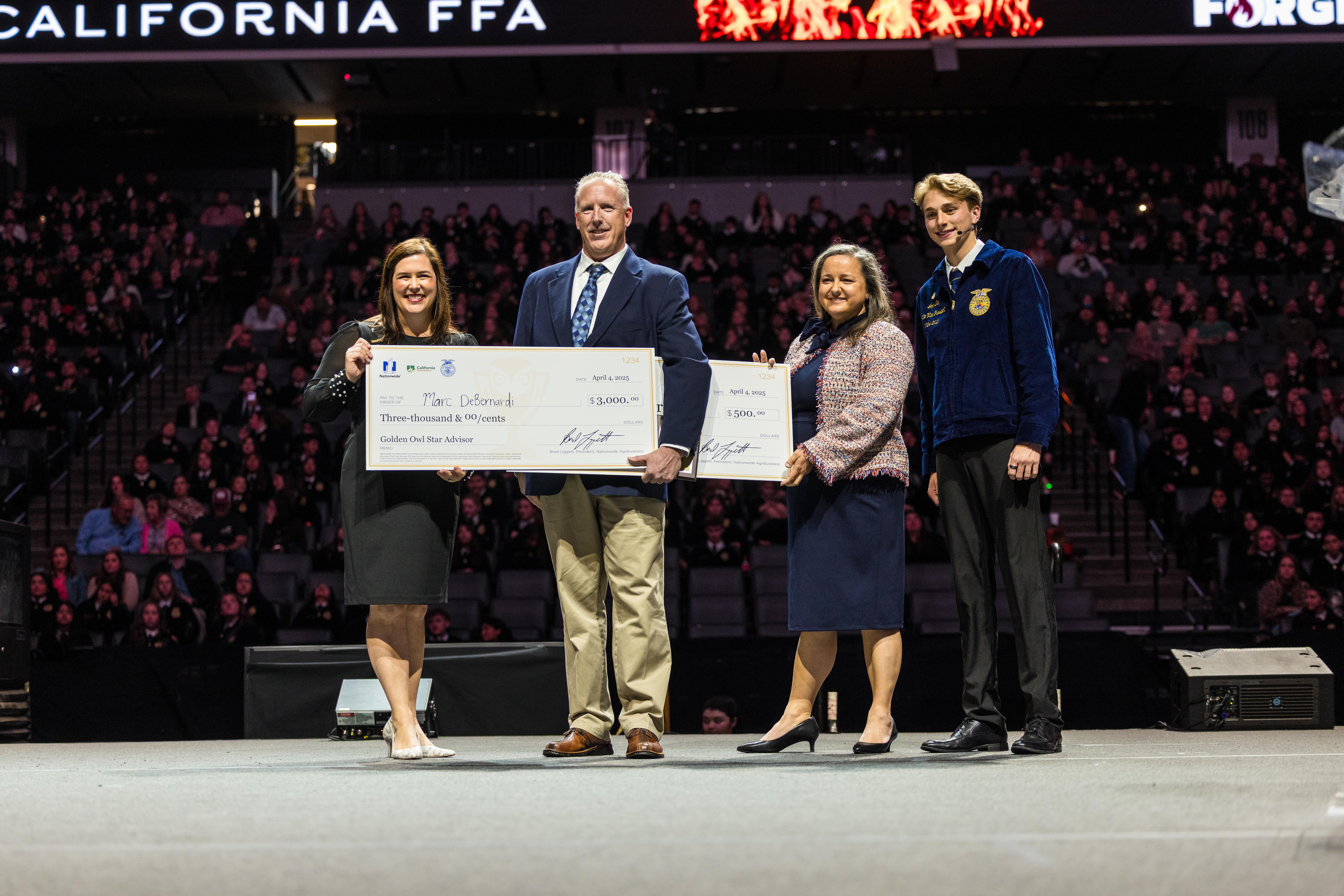 DeBernardi receives a check from sponsors