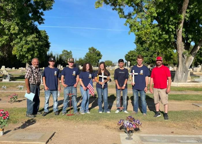 Gustine FFA placing flags on the graves of fallen military members. 